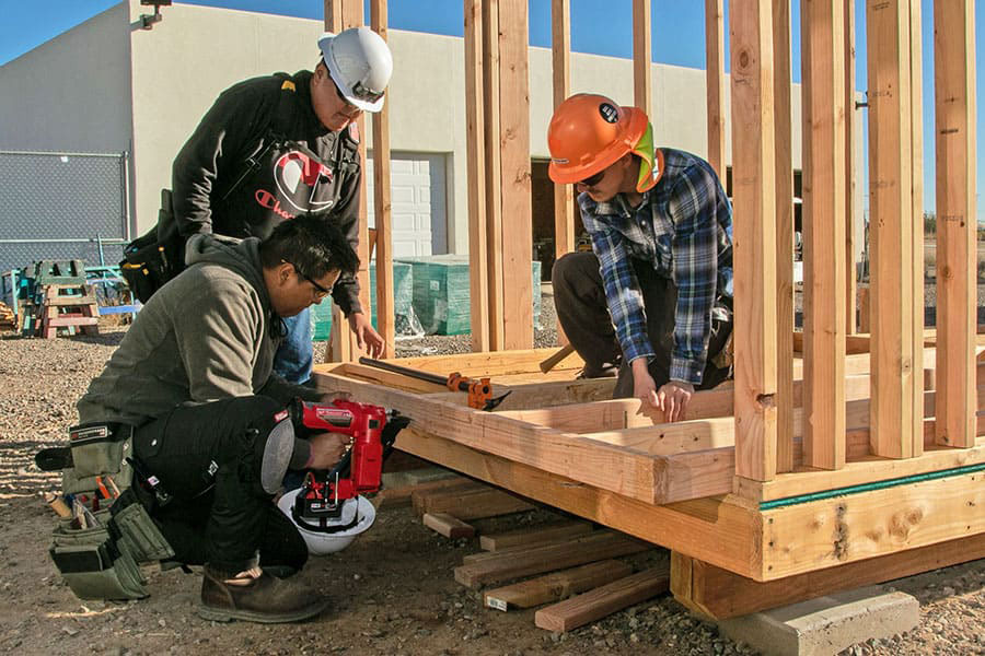 SJC Students building a wooden frame for a building