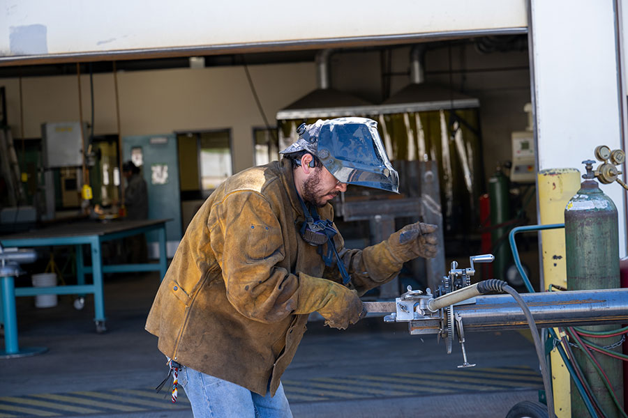 SJC Student at the welding lab on main campus practicing their techniques