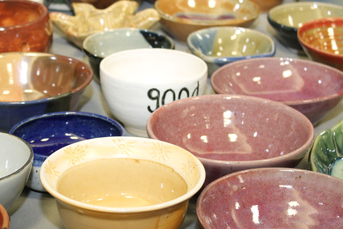 Collection of various pottery bowls in red, blue, yellow and white.