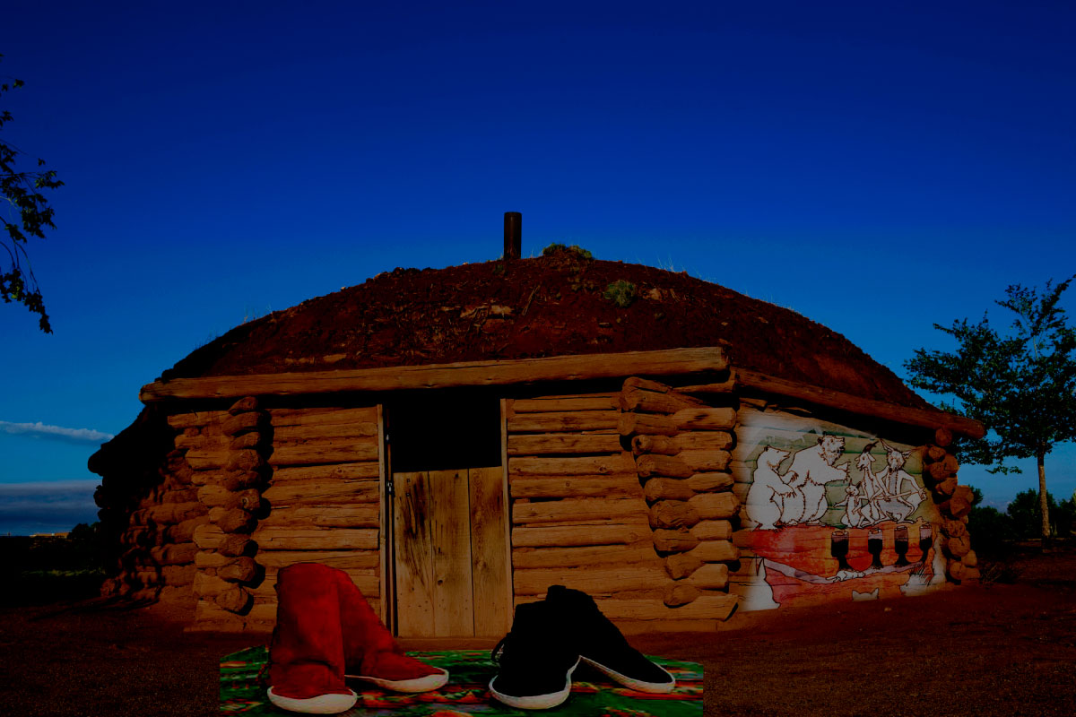 A Navajo traditional home with Navajo moccasins in front