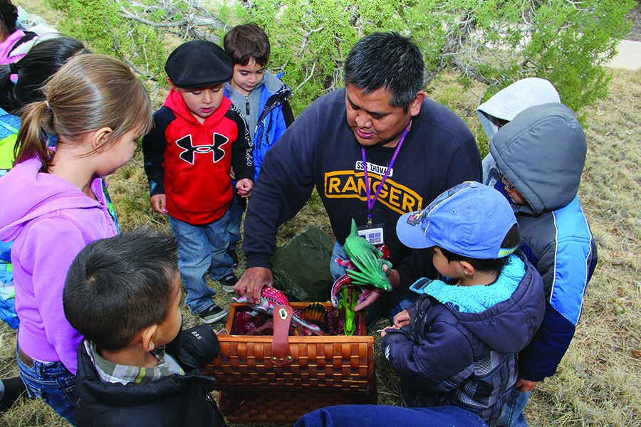 Young students with instructor outdoors exploring