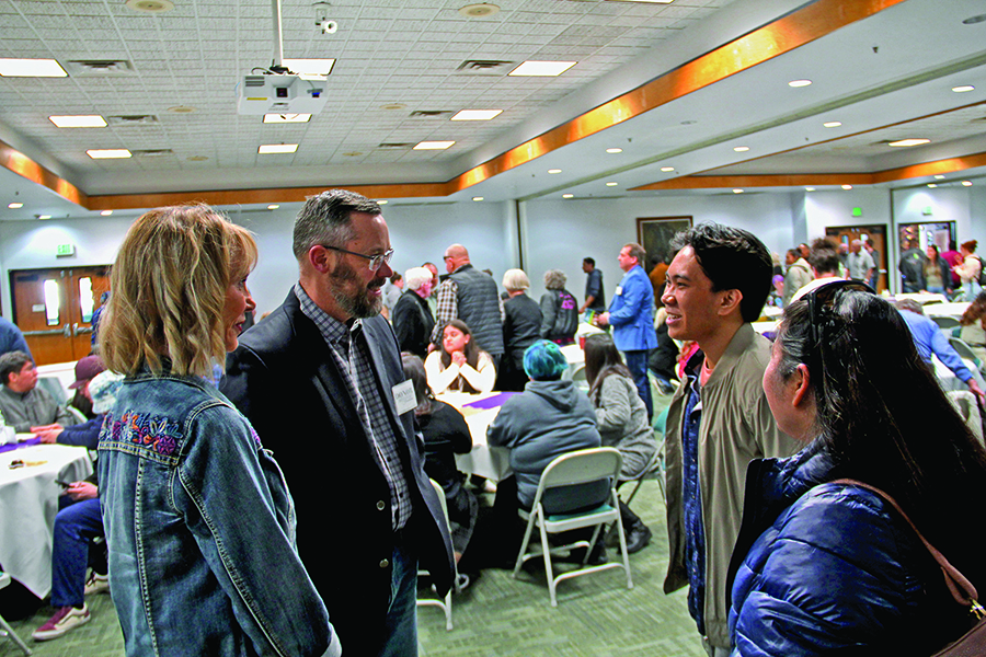 Four individuals chatting at the Scholarship reception