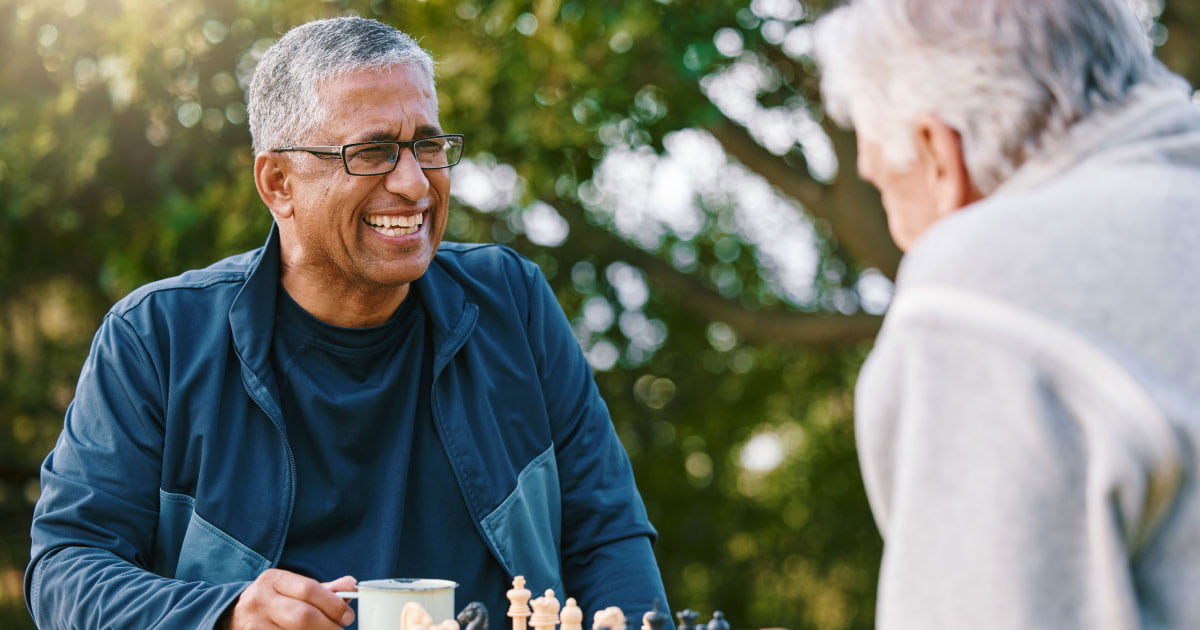 Smiling man, playing chess