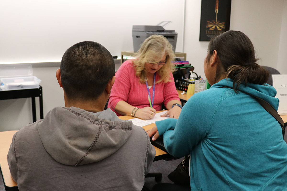 A couple has their taxes prepared by a volunteer.