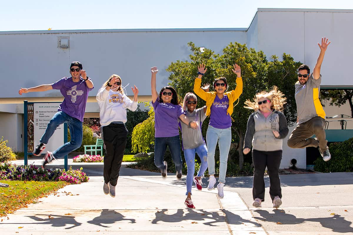 sjc students jumping and celebrating