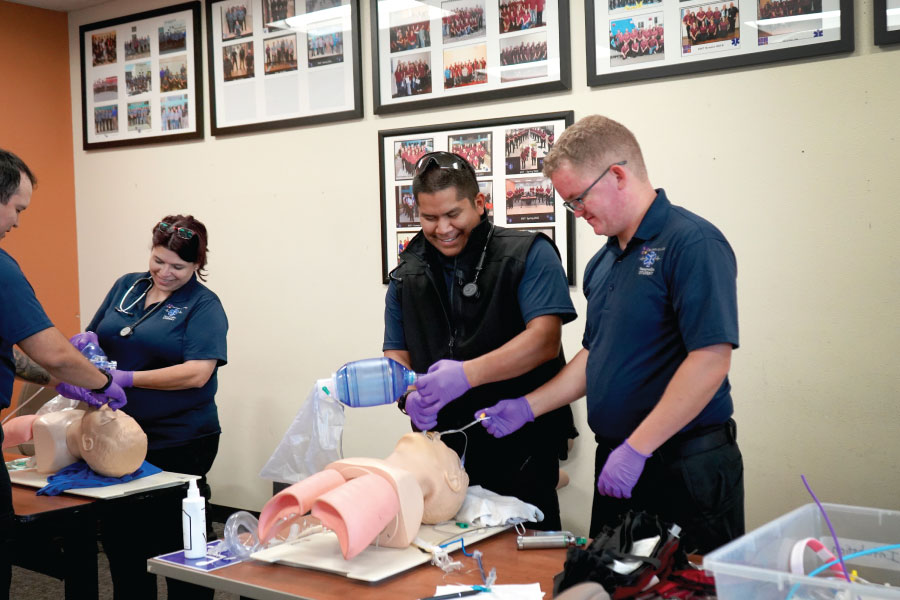 Multiple students practicing on dummies