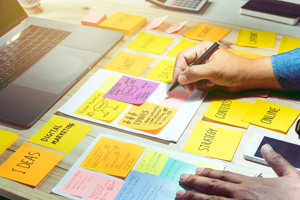 San Juan College student using sticky notes to lay out a marketing plan