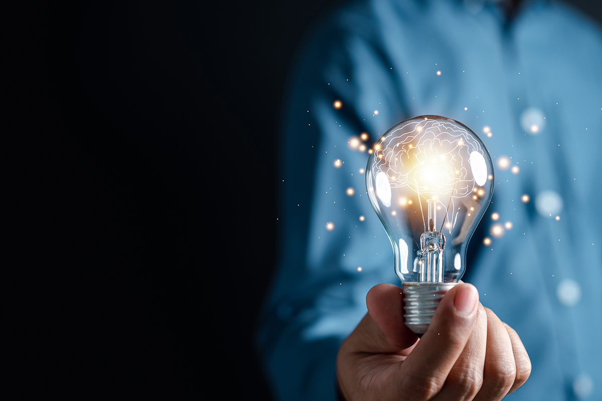 a person holding a bright light bulb