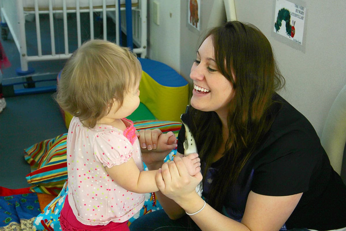 A CFDC teacher tending to a toddler