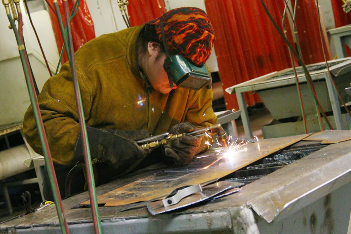 Student focuses on weld bead during shop time.