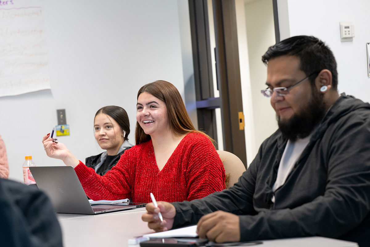 students in class smiling and asking questions