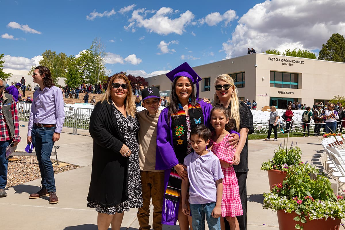 Family of San Juan College graduate celebrate and take photos together.