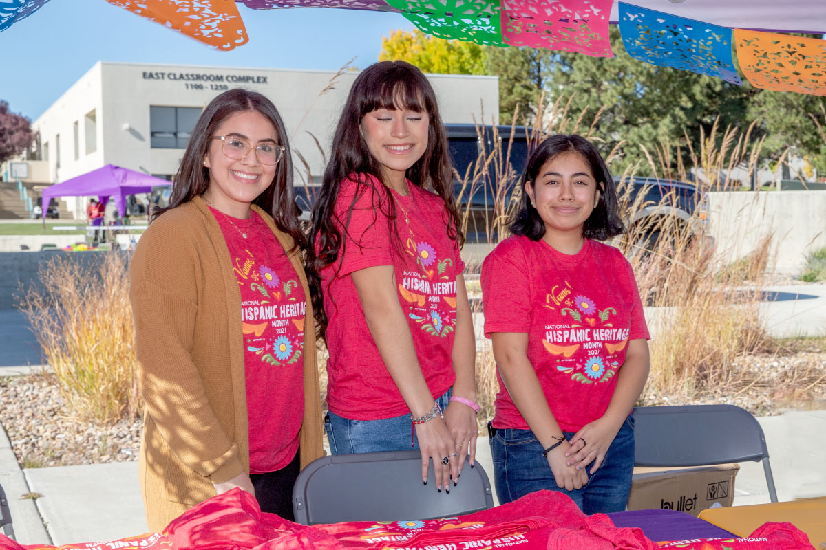 Three students wearing red shirts