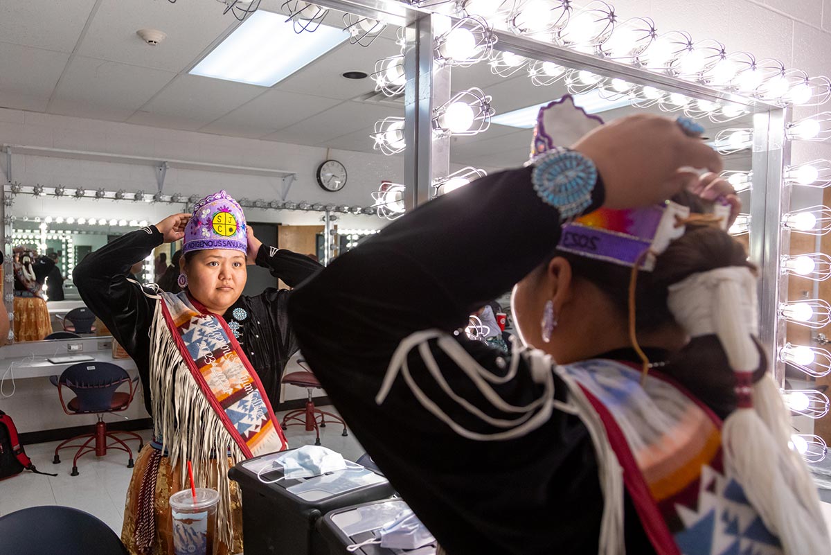 San Juan College Ms. Indigenous looking at herself in the mirror before Ms. Indigenous Pageant.