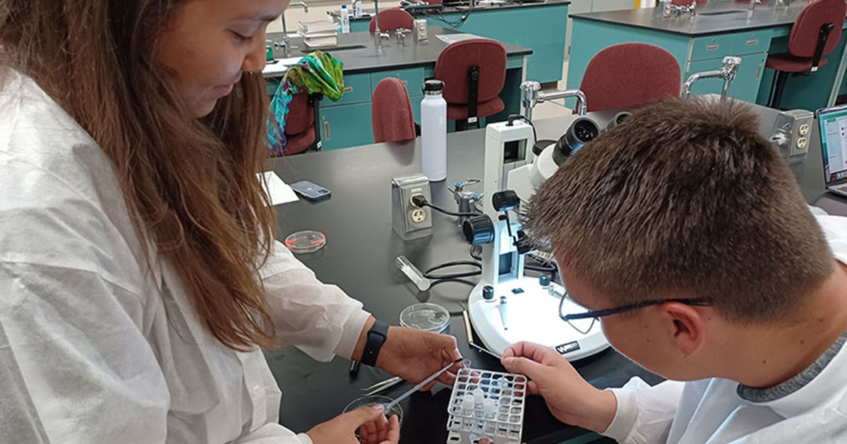 Science students working with samples in lab setting.